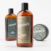 Zestaw-Groomen-trzy-brazowe-produkty-na-bialym-tle---zel-pod-prysznic-z-napisem-SHOWER-GEL-i-zlotym-logo,-szampon-z-napisem-HAIR-SHAMPOO-oraz-okragla-pomada-do-wlosow..jpg