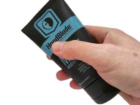 tube-of-Headblade-HeadLube-matte-held-in-hand-on-white-background.jpg